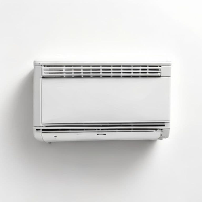 A slimline window air conditioning unit fitted into a bright European apartment window with the outdoor street visible beyond.
